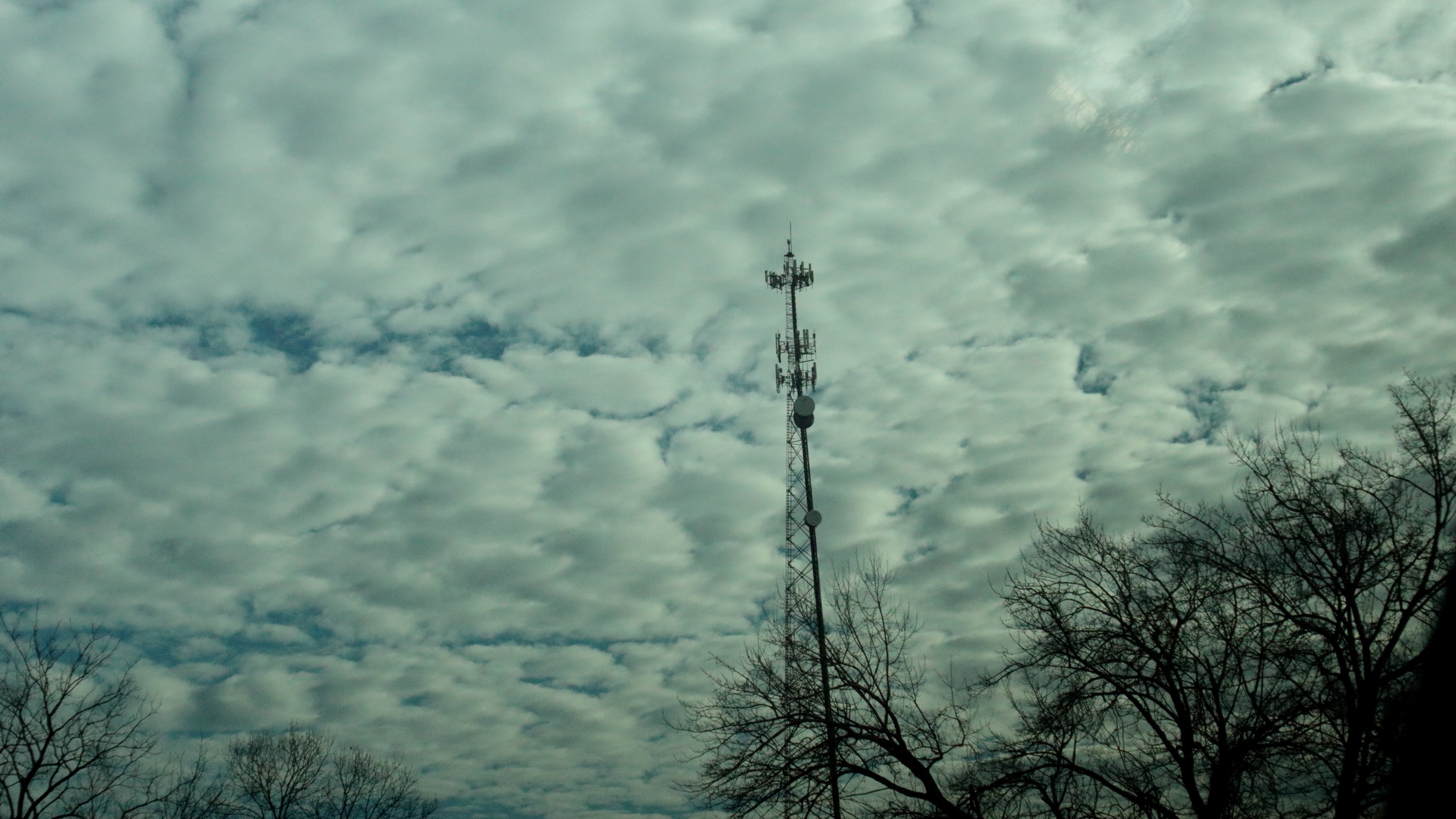 A picture of cloud cover, with a cell tower in front of it.